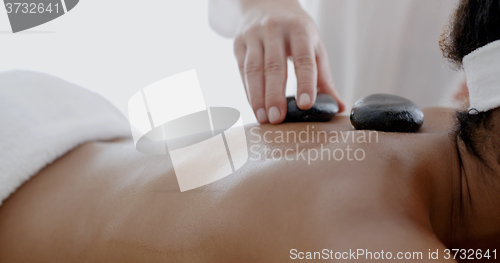 Image of Woman Receiving A Massage With Hot Stone