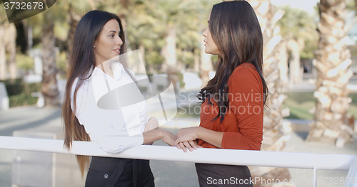 Image of Two young ladies standing talking