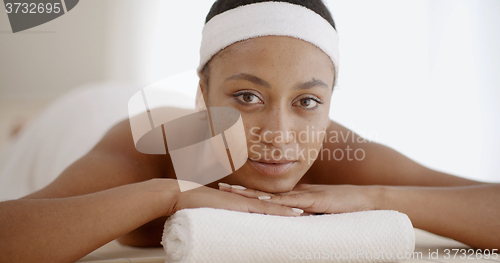 Image of African Woman Laying On Spa Table