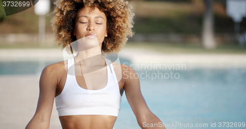 Image of Healthy Woman Meditating Near The Pool
