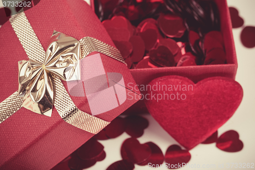 Image of Red hearts confetti on wooden background