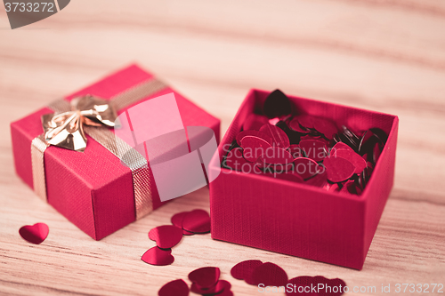 Image of Red hearts confetti on wooden background