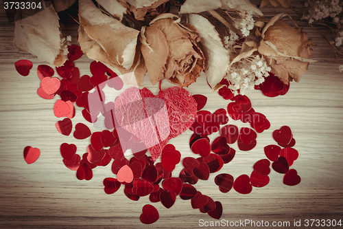 Image of bouquet of dried roses and red box, valentine