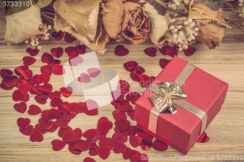 Image of Red hearts confetti on wooden background