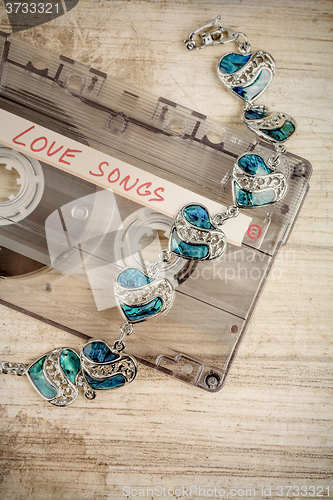 Image of Audio cassette tape and bracelet