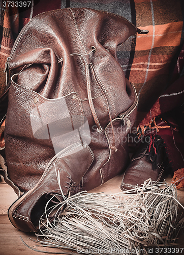 Image of Leather products against the background of wool tartan