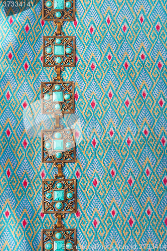 Image of Handmade belt on the  silk background