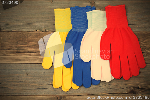 Image of working gloves on old boards