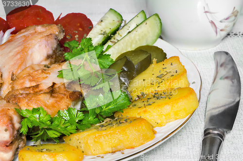 Image of Baked fish and vegetables .