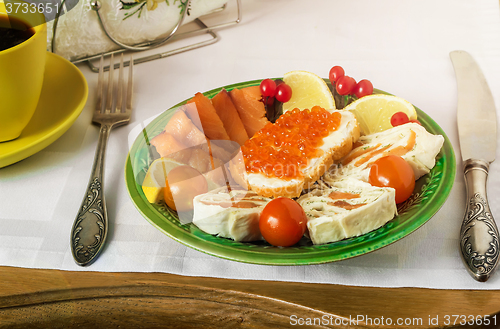 Image of Snacks with fish and black coffee.