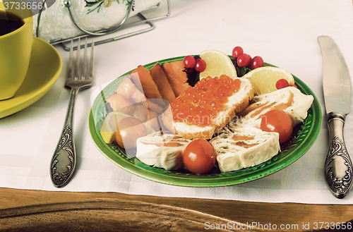 Image of Snacks with fish and black coffee.