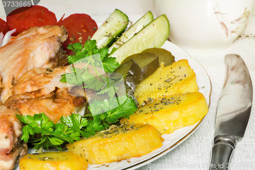 Image of Baked fish and vegetables .