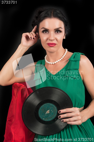 Image of Pretty girl holding retro vinyl disc