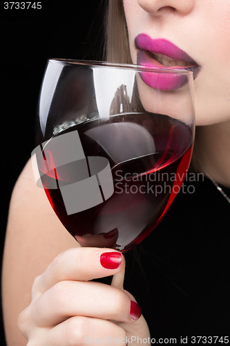 Image of woman with glass red wine. saturated color, nails.