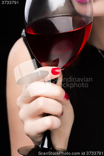 Image of woman with glass red wine. saturated color, nails.