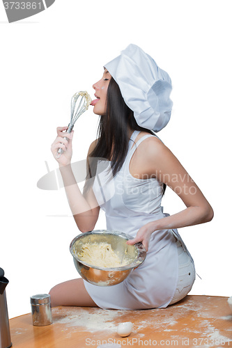 Image of sexy woman in chef uniform knead the dough