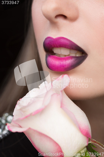 Image of Woman face with lilac Lips and Rose Flower.