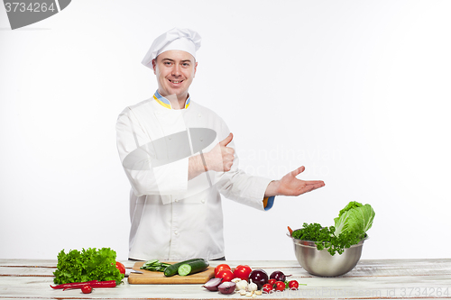 Image of Chef cooking fresh vegetable salad in his kitchen