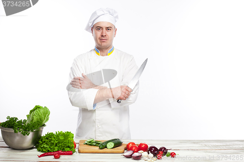 Image of Chef posing with knife in his kitchen