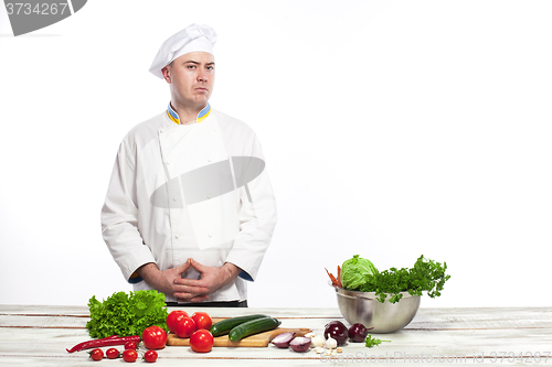 Image of Chef cooking fresh vegetable salad in his kitchen
