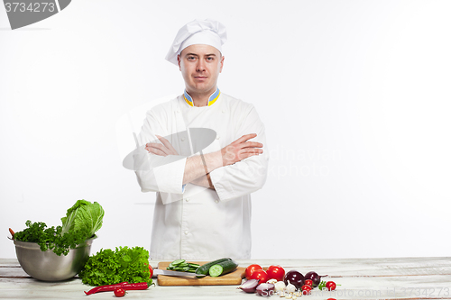 Image of Chef cooking fresh vegetable salad in his kitchen