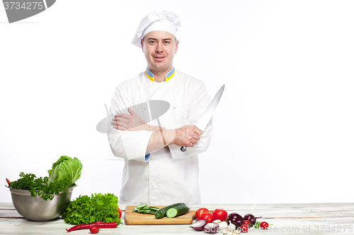Image of Chef posing with knife in his kitchen