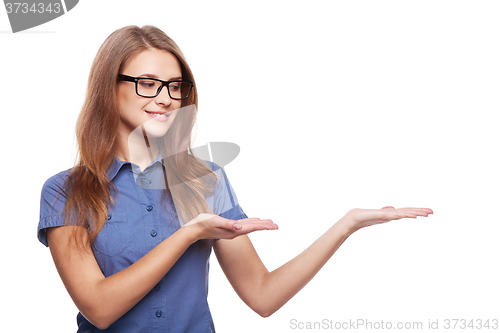 Image of Smiling business woman showing open hand palm