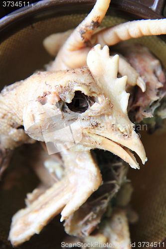 Image of chicken head and leg as food