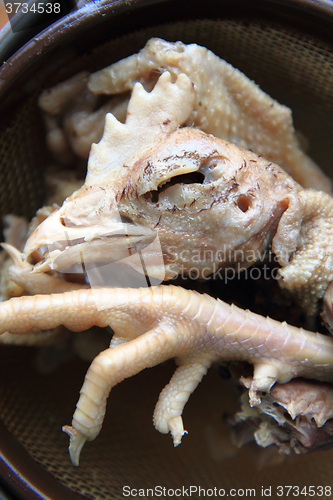 Image of chicken head and leg as food