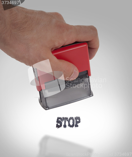 Image of Plastic stamp in hand, isolated