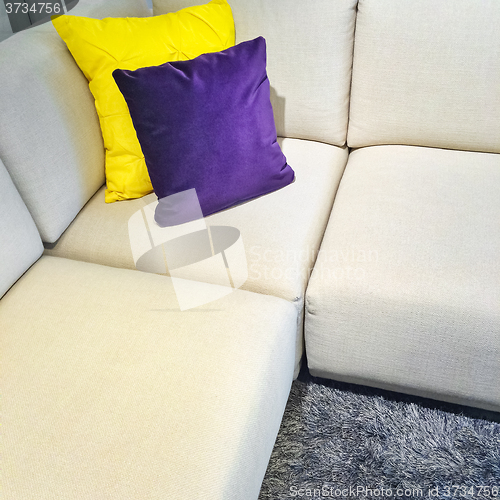 Image of White corner sofa with colorful cushions