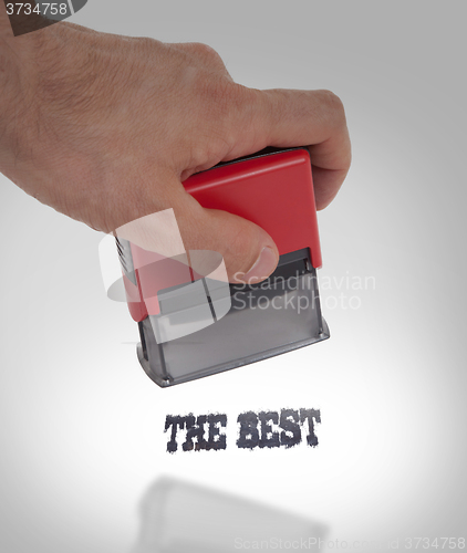 Image of Plastic stamp in hand, isolated