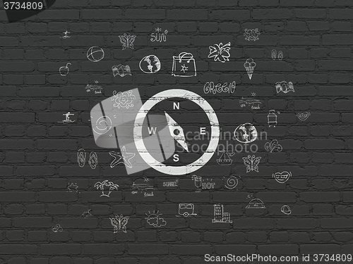 Image of Tourism concept: Compass on wall background