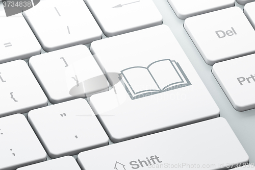 Image of Learning concept: Book on computer keyboard background