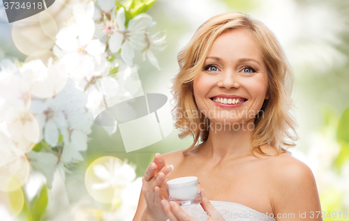 Image of happy woman with cream jar