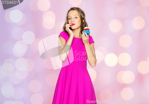 Image of happy woman or teen girl with birthday cupcake