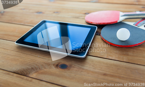 Image of close up of table tennis rackets and tablet pc