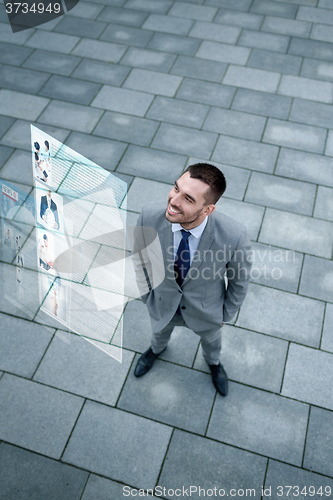 Image of young smiling businessman outdoors from top