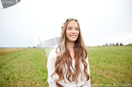 Image of smiling young hippie woman on cereal field