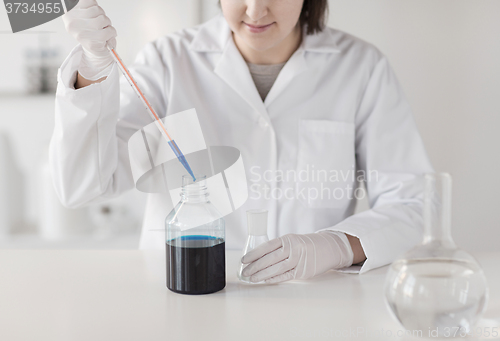 Image of close up of scientist making test in lab