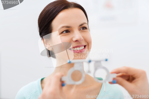 Image of happy woman having vision test at eye clinic