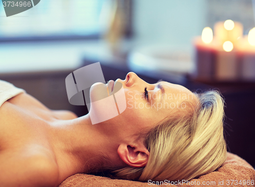Image of close up of young woman lying in spa