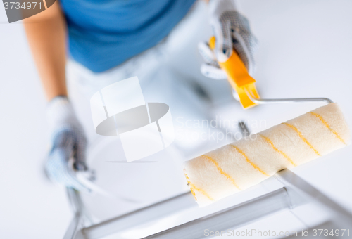 Image of woman with roller and paint pot