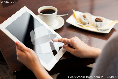 Image of close up of woman with tablet pc and coffee