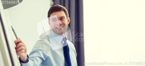 Image of smiling businessman on presentation in office