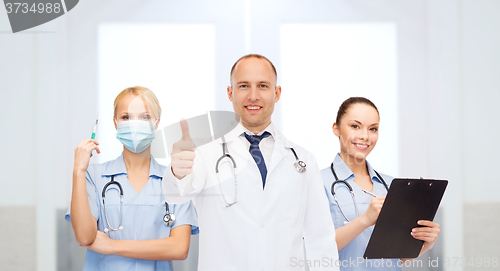Image of group of doctors at hospital showing thumbs up