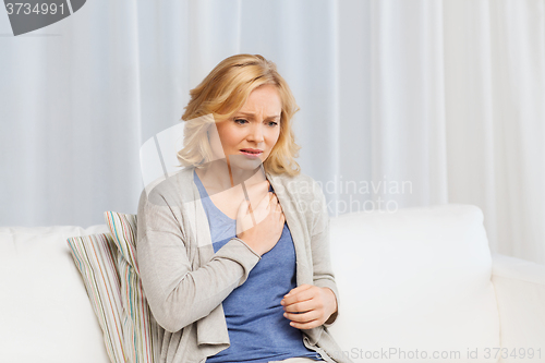 Image of unhappy woman suffering from heartache at home