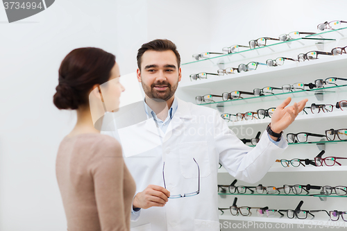 Image of woman and optician showing glasses at optics store