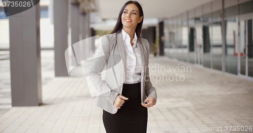 Image of Business woman adjusting her hair outdoors