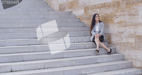 Image of Business woman sitting with crossed legs